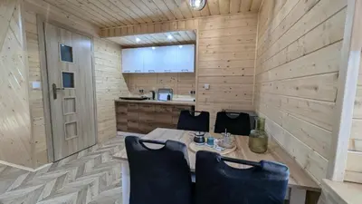 a wooden room with a bed and a staircase at Domek wypoczynkowy Górskie Zacisze in Sidzina