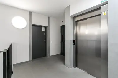 a hallway with elevator doors in a building at Premium Apartment in Kossak Residence in Kraków