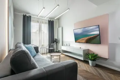 a living room with a couch and a table at Premium Apartment in Kossak Residence in Kraków