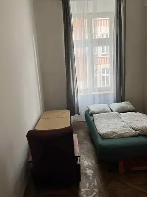 two beds in a room with a window at Old Town Rooms Wielopole in Kraków