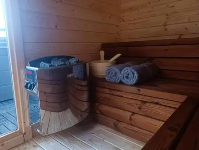 a sauna with blue towels in a wooden cabin at Mucharskie Stodoły Stodoła II - Garden Spa in Jaszczurowa