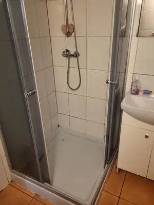 a bathroom with a shower and a sink at Grzegorzecka Room nr 1 in Kraków