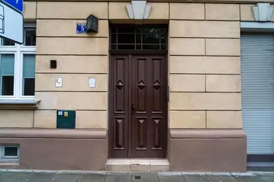 a brown door on the side of a building at Asnyka Old Town in Kraków