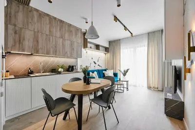 a kitchen and dining room with a table and chairs at Golden Dreams Luxury Apartment 81 in Kraków