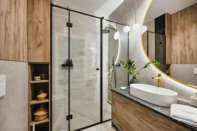 a bathroom with a sink and a shower at Golden Dreams Luxury Apartment 81 in Kraków