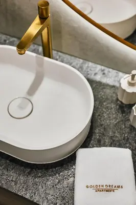a bathroom sink with a white toilet and a golderefficient at Golden Dreams Luxury Apartment 81 in Kraków