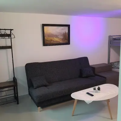 a living room with a couch and a table at Domek Muchomorek 1km od Energylandii in Zator