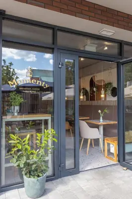 a restaurant with sliding glass doors and a table at River Side Residence 3/18 in Oświęcim