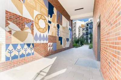a hallway with a mural on the side of a building at GH Luxury Apartment in Kraków