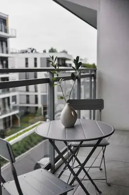 a white vase sitting on a table on a balcony at Golden Dreams Luxury Apartments 103 in Kraków