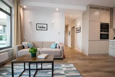 a living room with a couch and a table at InPoint Wawel View Apartments- Free Underground Parking in Kraków