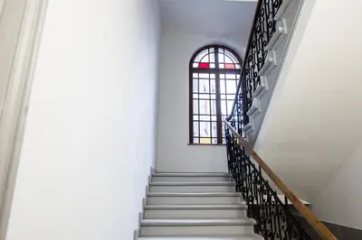 a staircase in a building with a window at CracWoW K8 No.11 Apartment in Kraków