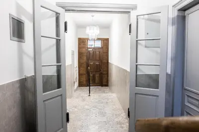 a hallway with a door leading to a room at CracWoW K8 No.11 Apartment in Kraków