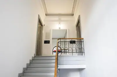 a staircase in a building with a chair on it at CracWoW K8 No.8 Apartment in Kraków