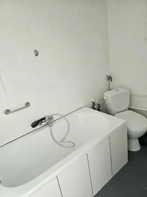a white bathroom with a sink and a toilet at Cozy studio in Cracow in Kraków