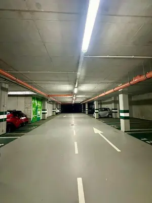 an empty parking garage with cars parked in it at Beautiful Apartment- FREE GARAGE- WIŚLANE TARASY in Kraków