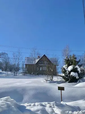 a house in a field covered in snow at Apartament Guziczek2 in Nowy Targ
