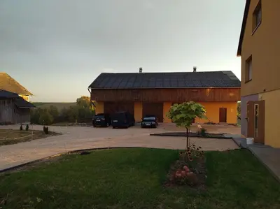 a building with cars parked in a parking lot at Noclegi nad S-ką in Miechów