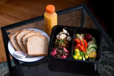 a lunch box with a sandwich and a plate of food at Native Apartments Pułaskiego 6 in Kraków