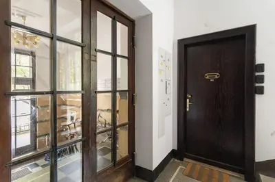 a wooden door in a room with a window at May A studio in Kraków