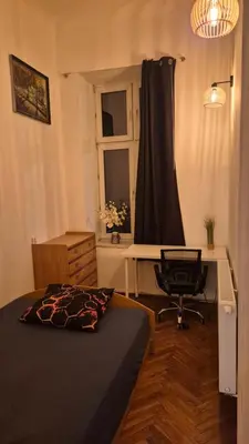 a bedroom with a bed and a desk and a chair at Agnieszki Pokoj nr 2 in Kraków
