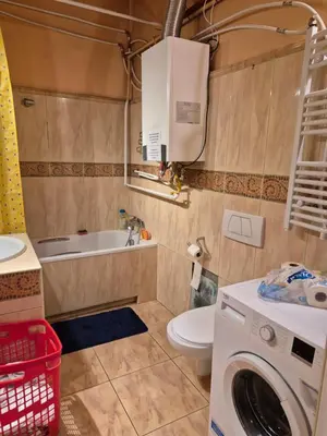 a bathroom with a toilet and a washing machine at Agnieszki Pokoj nr 3 in Kraków
