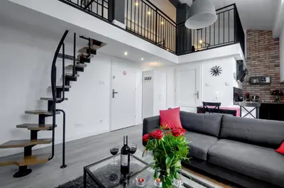 a living room with a couch and a glass table at Zamkowa15 Apartments in Kraków