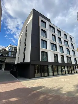 a large white building with a lot of windows at Vistula Avenue Apartment free Parking in Kraków
