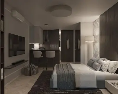 a bedroom with a king sized bed and a kitchen at Prestiżowy apartament B in Kraków
