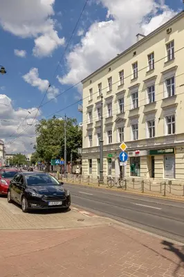 a black car parked in front of a building at 1 Bedroom Apartment with AC - Dluga 65 Street in Kraków