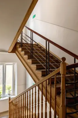 a staircase in a house with wooden railings at 1-Bedroom Apartment - 65 Długa Street in Kraków