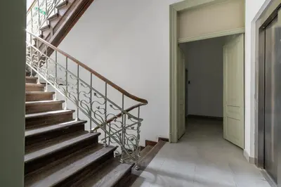 a wooden staircase in a house with a door at Balcony Apartment - Kazimierz- Starowiślna 41 in Kraków