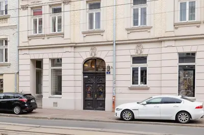 two cars parked in front of a building with a door at Balcony Apartment - Kazimierz- Starowiślna 41 in Kraków