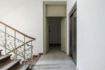 a hallway with stairs in a house at Balcony Apartment - Kazimierz- Starowiślna 41 in Kraków