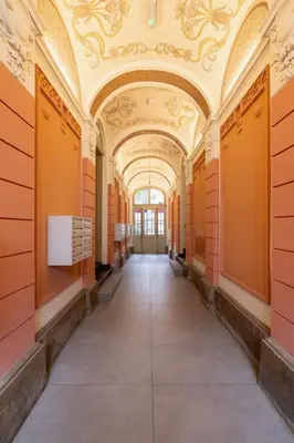 an empty hallway in a building with an ornate ceiling at Apartment with Balcony - Kazimierz- Starowiślna 41 in Kraków