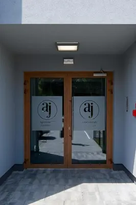 a door to a building with two signs on it at Moonlight by Housine in Zator