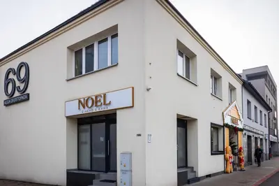 a white building with a noel sign on it at Apartment Close to the Center in Kraków