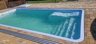 a swimming pool with a wave in the water at Energylandia Domki-Apartamenty u Agi G in Zator