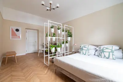 a bedroom with a bed with plants on a shelf at Apartment with balcony - Rejtana 10 in Kraków