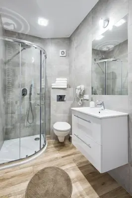 a bathroom with a shower and a toilet and a sink at Old Town Apartments - B12 in Kraków