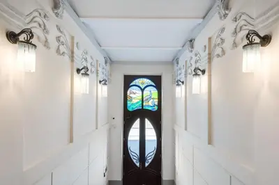 a hallway with a door with a stained glass window at Old Town Apartments - B12 in Kraków