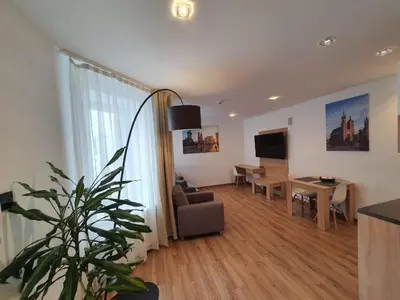 a living room with a couch and a table at Old Town Apartments - B34 in Kraków