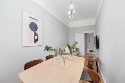 a dining room with a wooden table and chairs at 2 - bedroom Apartment with balcony - Rejtana 10 in Kraków