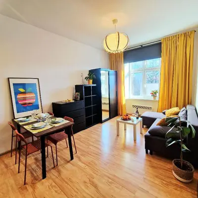 a living room with a table and a couch at Old Town Apartments - B6A in Kraków