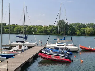 a group of boats are docked at a dock at Bagry Rooms2 - Apartament z sypialnią i miejscem postojowym in Kraków
