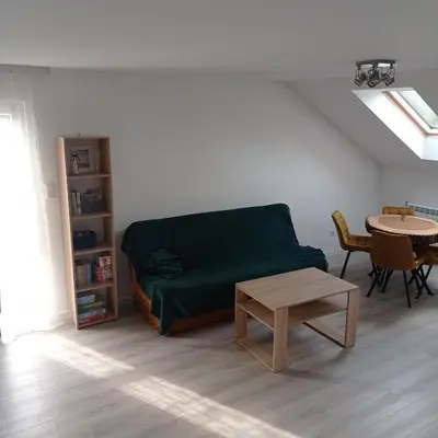 a living room with a green couch and a table at U Tofika in Grzechynia