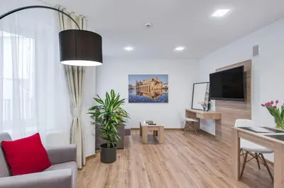 a living room with a couch and a table and a tv at Old Town Aptartments - B23 in Kraków