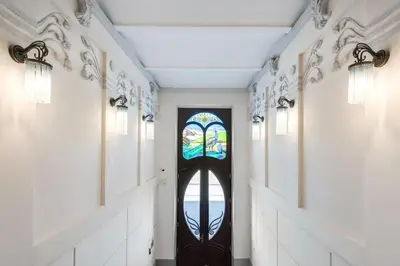 a hallway with a door with a stained glass window at Old Town Aptartments - B23 in Kraków