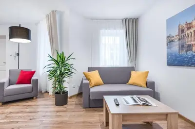 a living room with a couch and a table at Old Town Aptartments - B23 in Kraków
