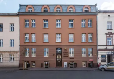 a large brick building with a clock on it at Cozy Apartment - B38 in Kraków